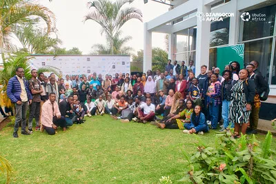 The DjangoCon Africa 2025 community group photo on the lawn in Arusha