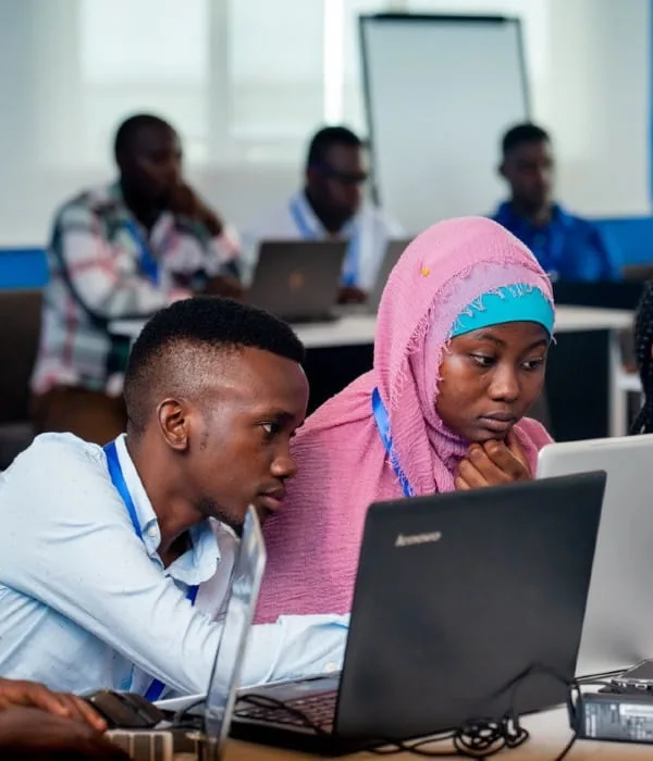 Two attendees working through a session together at PyCon Tanzania 2019