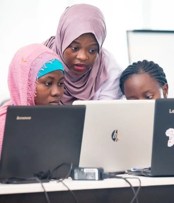Attendees helping each other during a workshop at PyCon Tanzania 2019