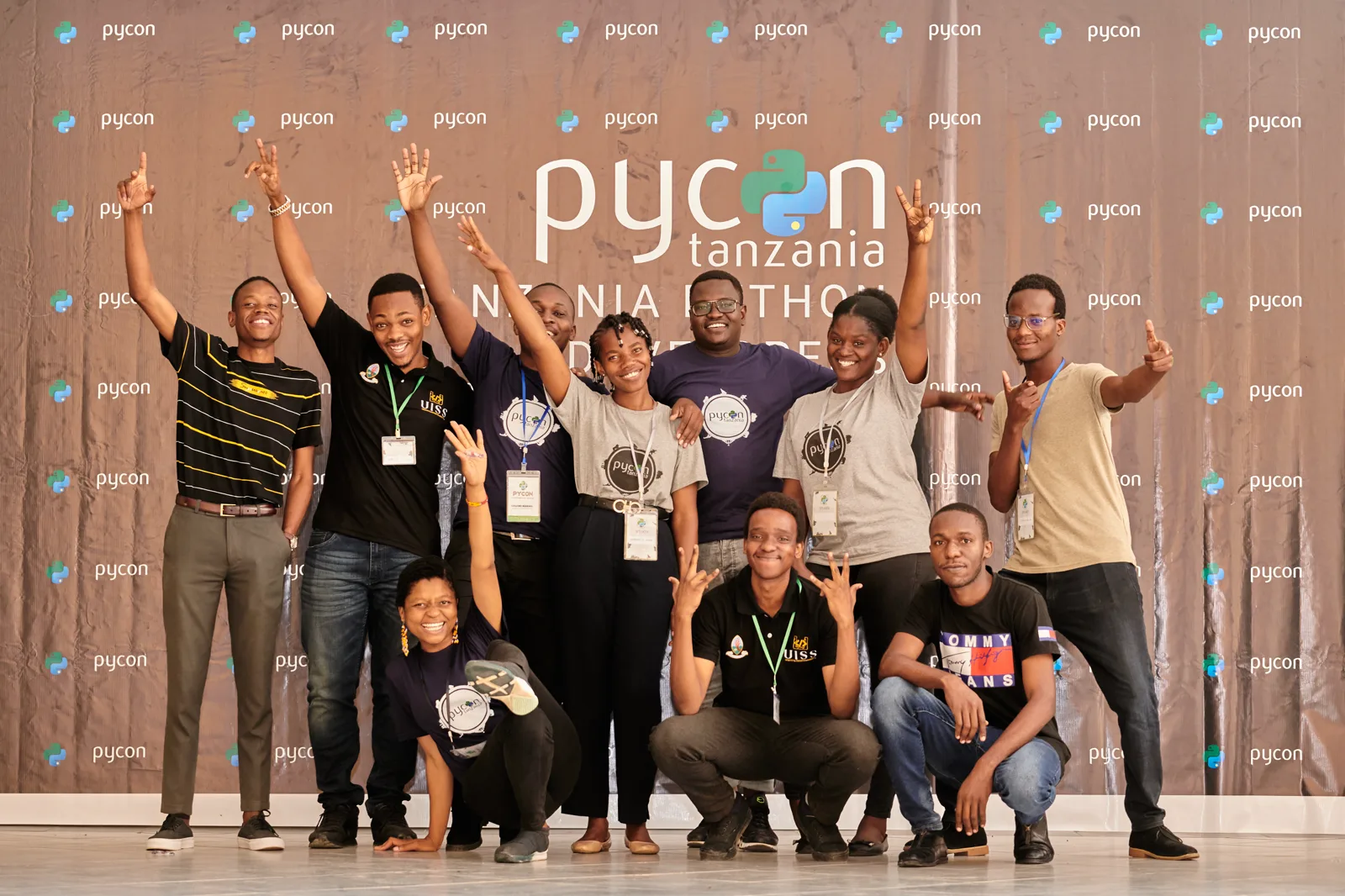 The PyCon Tanzania community gathered in front of the conference backdrop