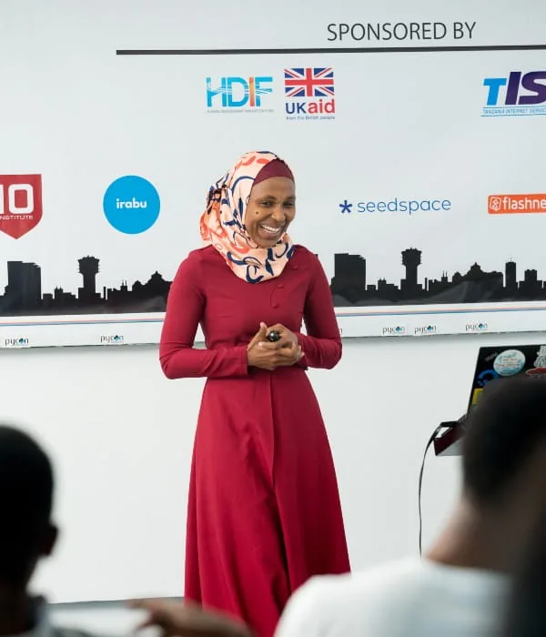 A speaker presenting on stage at PyCon Tanzania