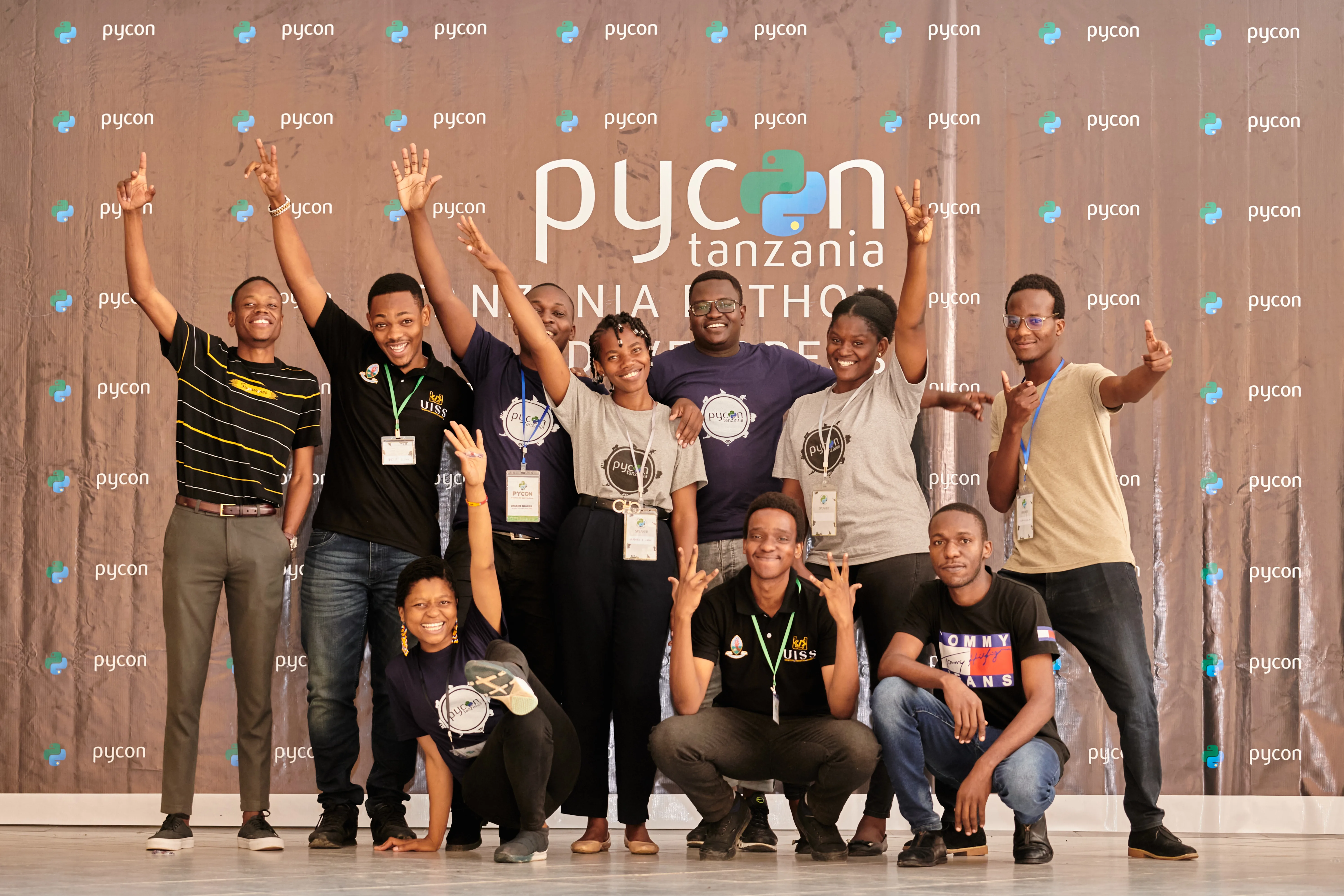 The PyCon Tanzania community gathered in front of the conference backdrop